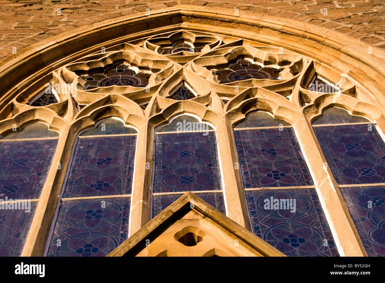Large 1800`s arched Gothic style windows of the Lochee Parish Church in rural Dundee,UK Stock Photo
